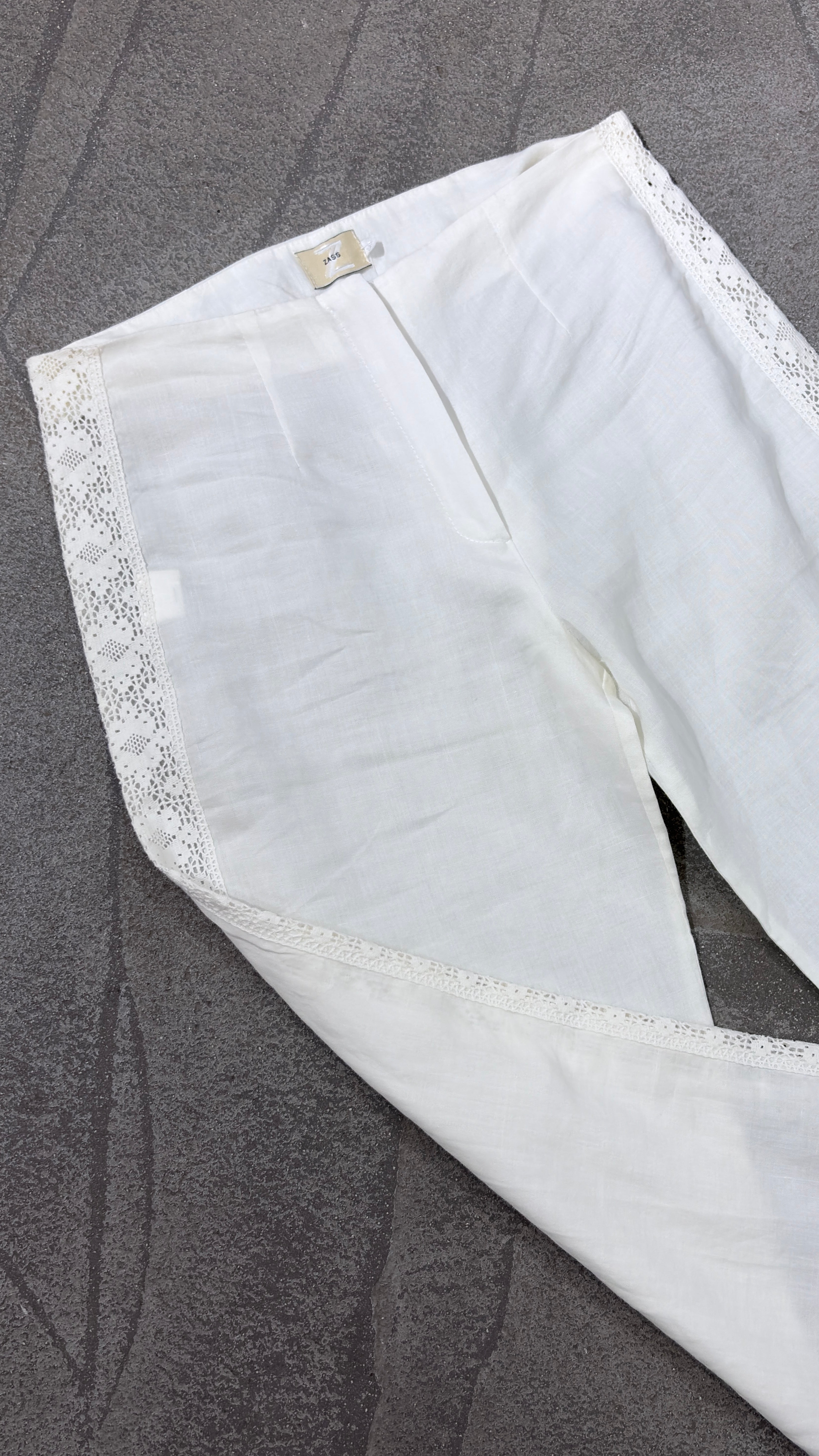 White linen pants with embroidered leg