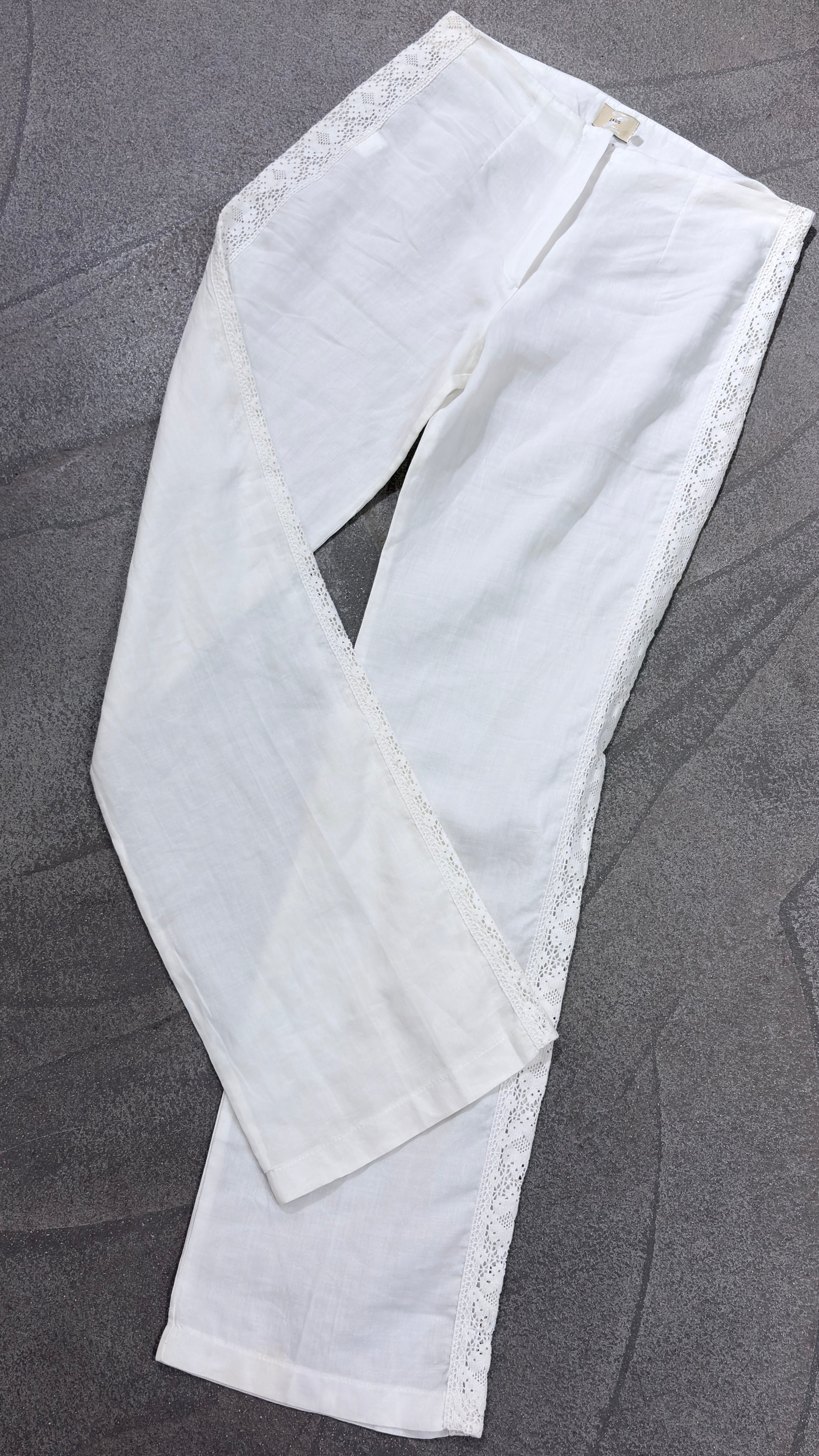 White linen pants with embroidered leg
