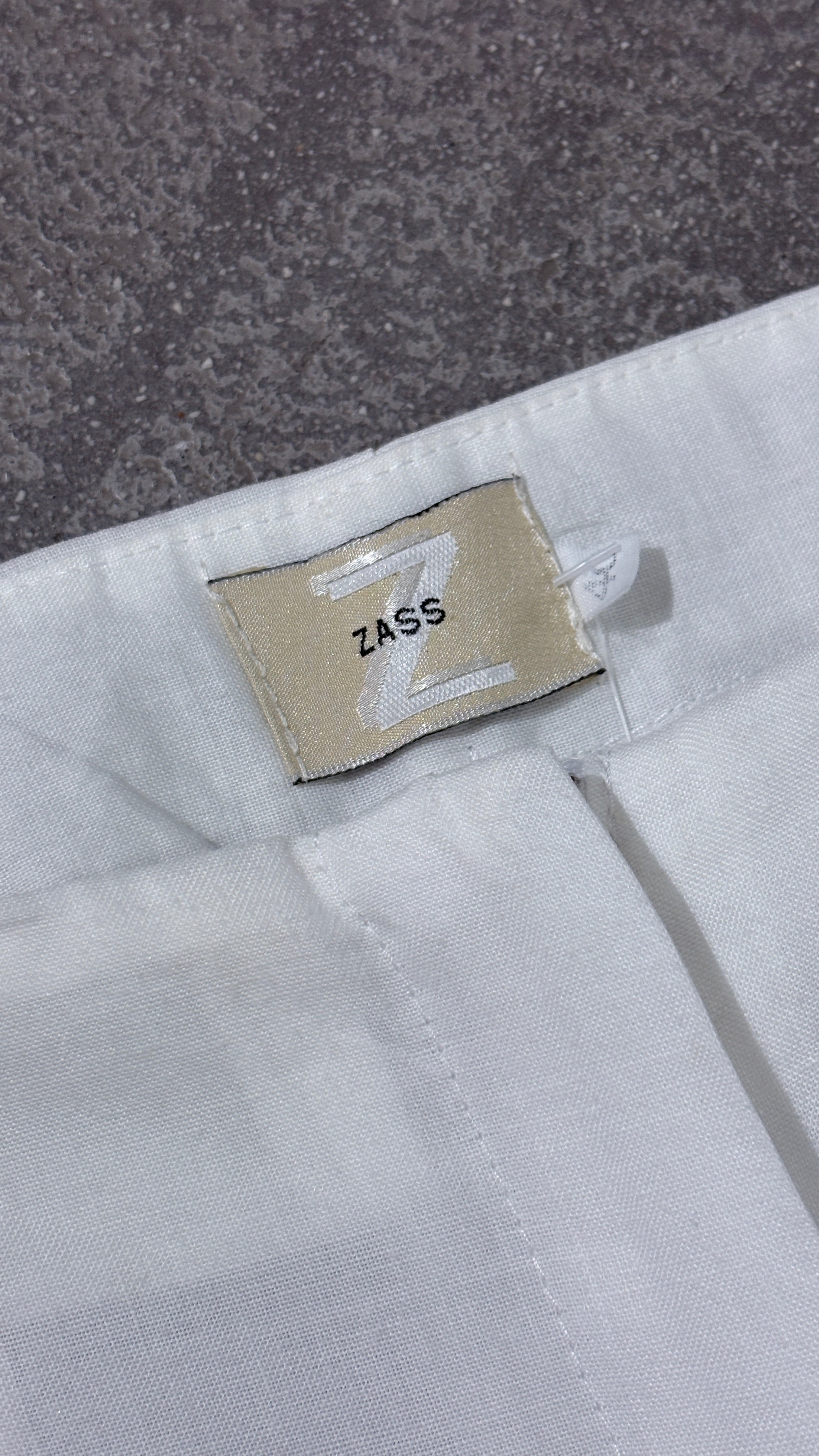 White linen pants with embroidered leg
