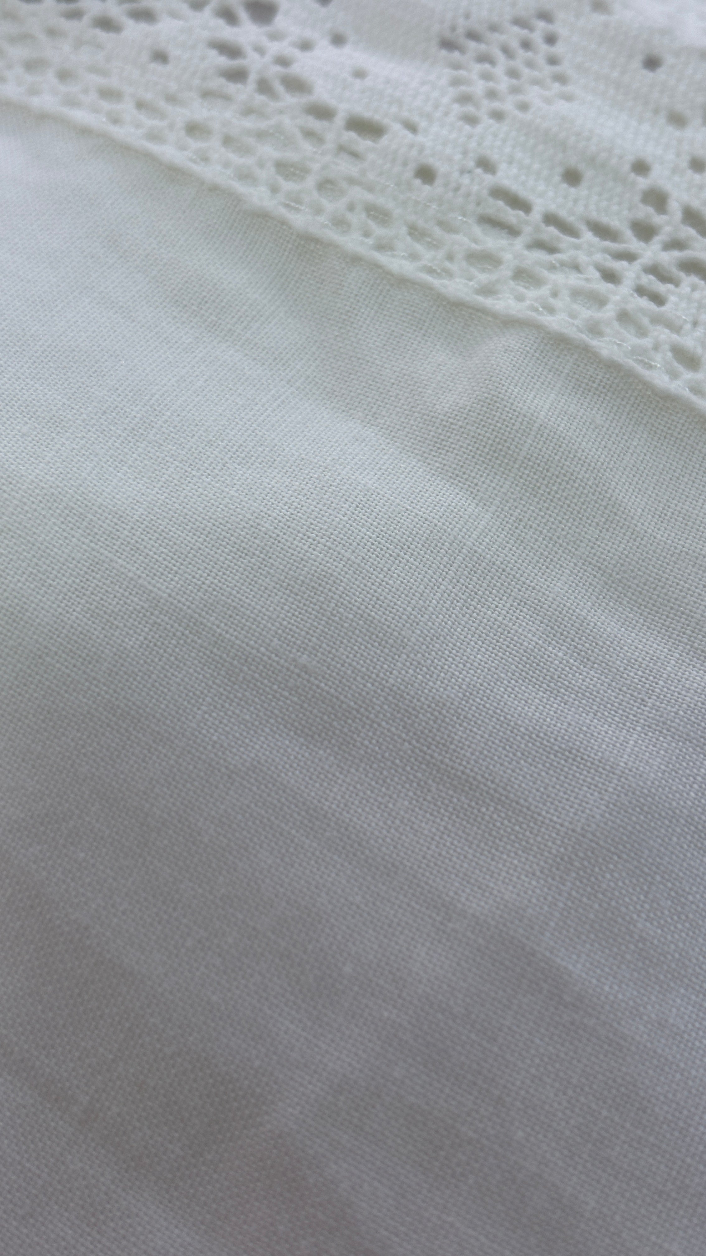 White linen pants with embroidered leg