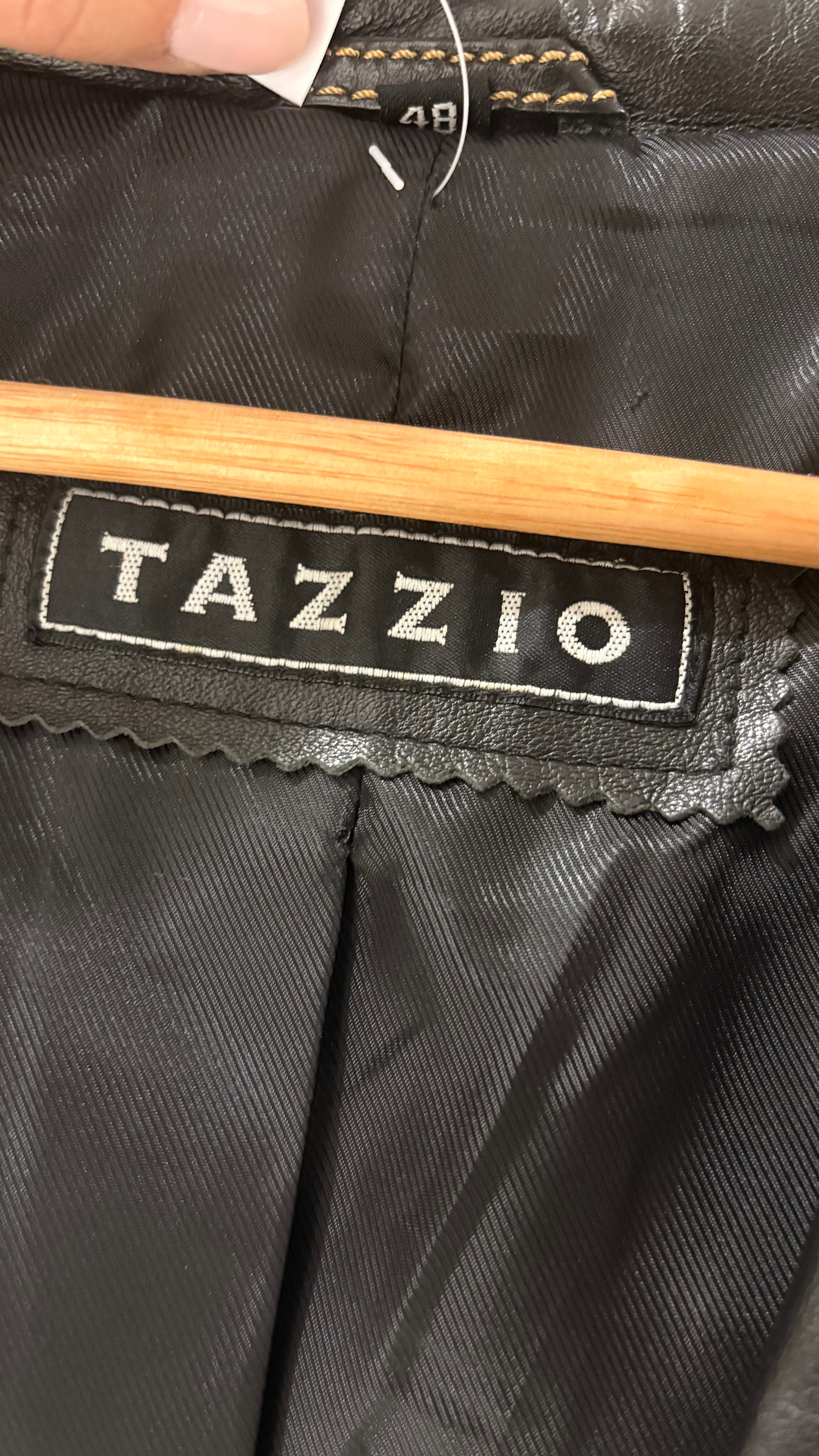 Black natural leather blazer with visible seam detailing and a cinched waist.